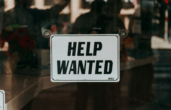 Help Wanted sign on a window