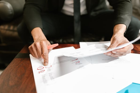 Close-up of Person pointing on Documents